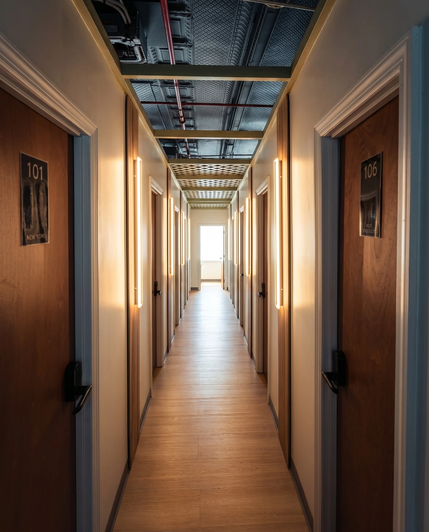 The CityNest hotel corridor, with warm light and private room entrances