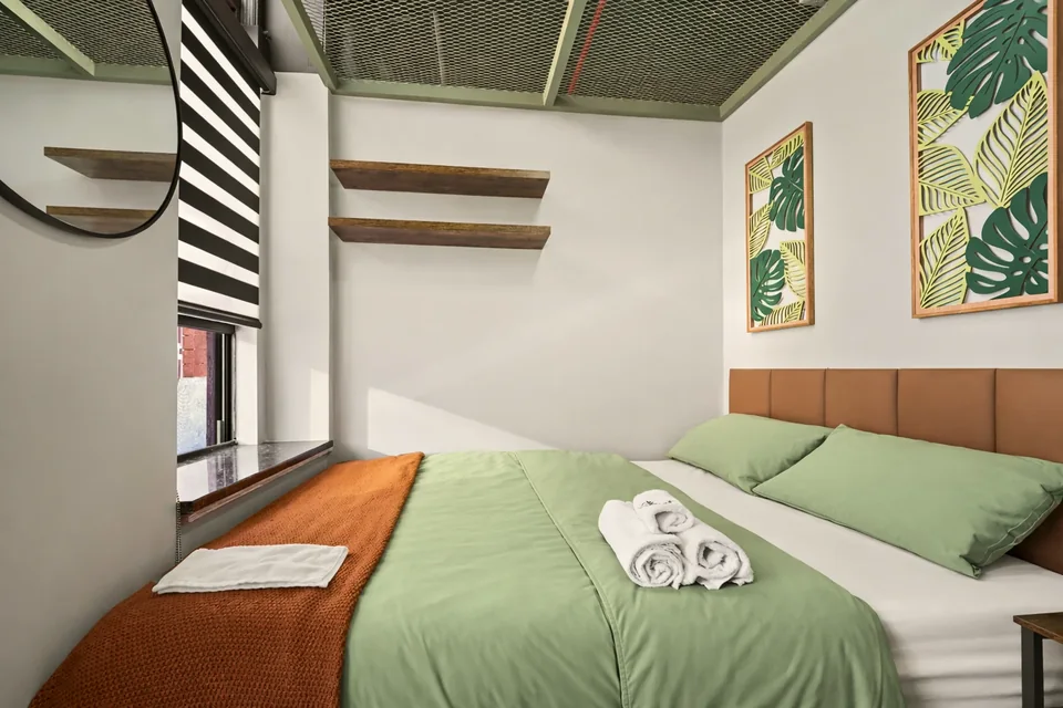 Full Nest Plus: real room photography showing bed, window and work surface